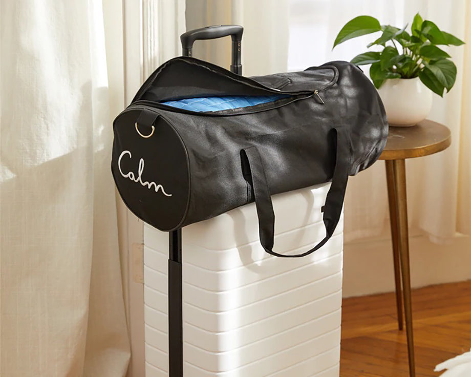a duffel bag with a rolled up weighted blanket