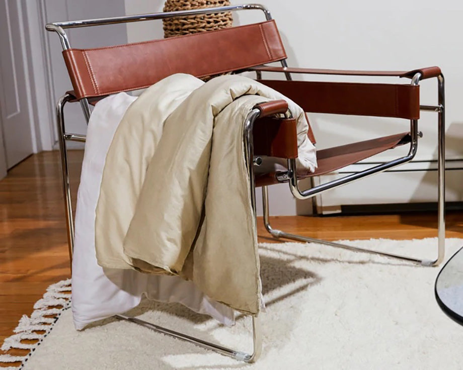 a weighted blanket hanging off of a chair