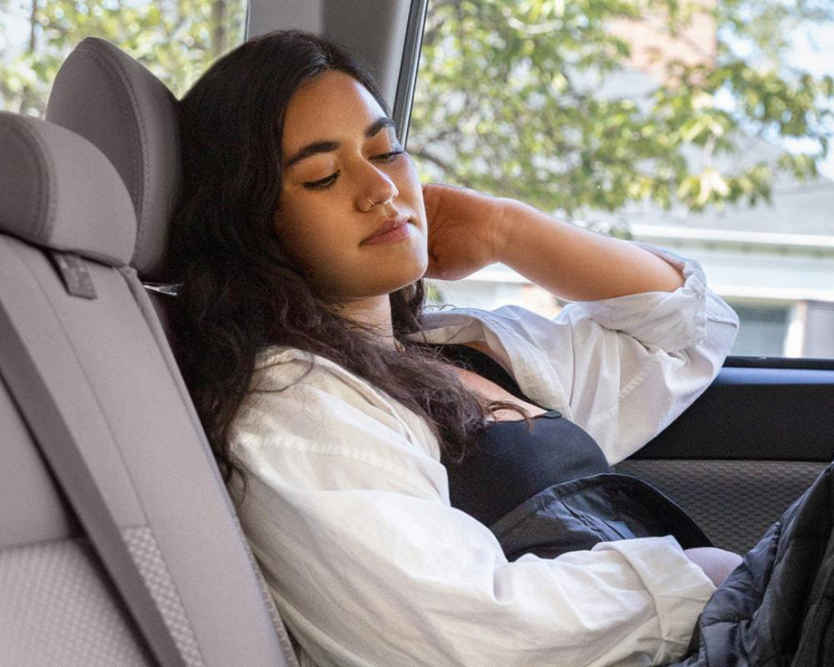 a woman asleep in her car