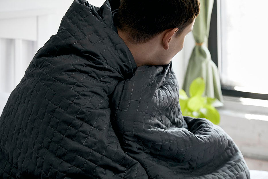 man wrapped in gravity blanket