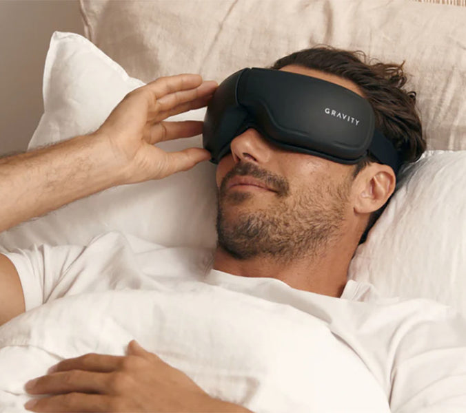 resting man wearing gravity eye massager