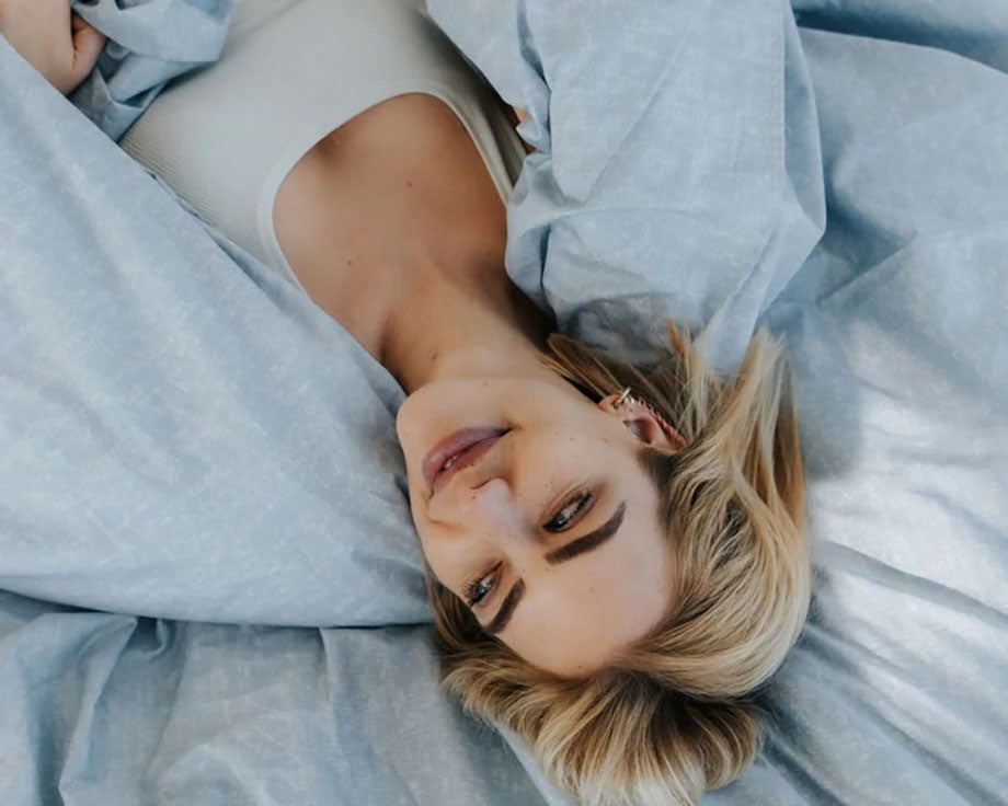 smiling woman lying in bed