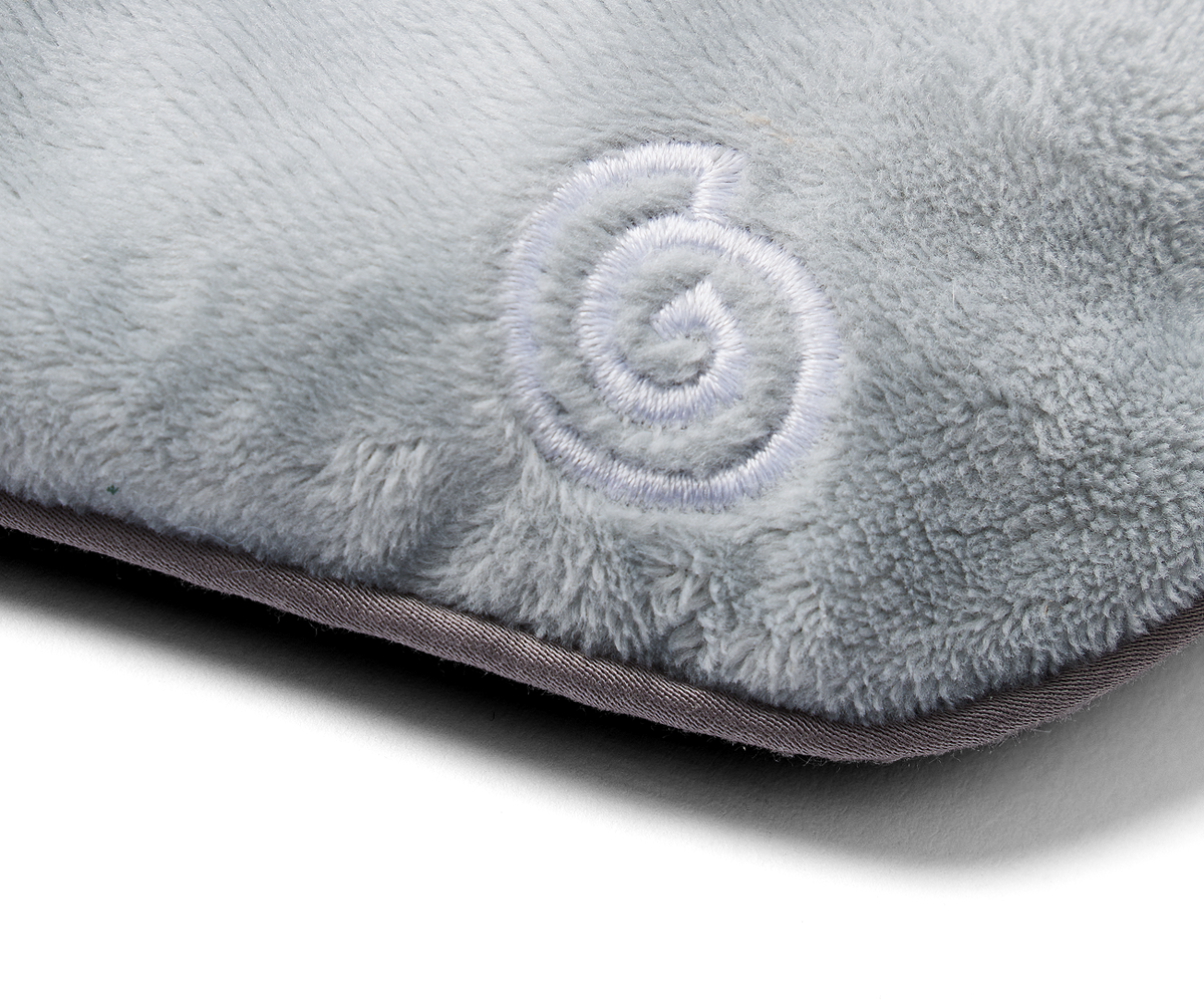 Close-up of a light grey gravity weighted eye mask