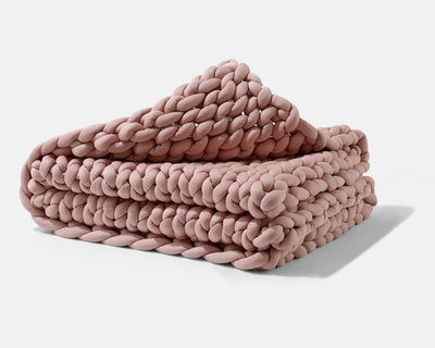 A folded Clay Gravity Weighted Chunky Knit Blanket - #color_clay