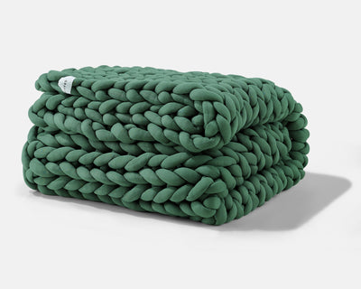 A folded Deep Forest Gravity Weighted Chunky Knit Blanket - #color_deep-forest