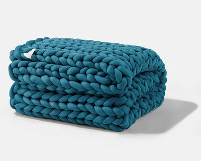 A folded Sapphire Blue Gravity Weighted Chunky Knit Blanket - #color_sapphire-blue