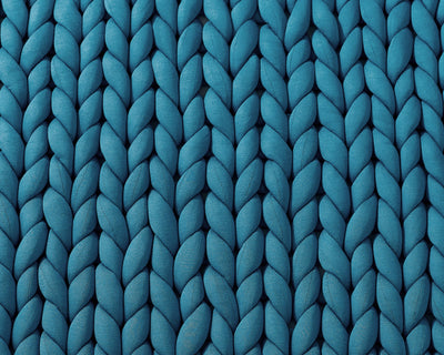 Closeup on the texture of the Sapphire Blue Gravity Weighted Chunky Knit Blanket - #color_sapphire-blue