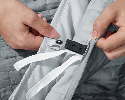 A button fastener shown on a Classic Grey Gravity Weighted Cooling Blanket - #color_classic-grey