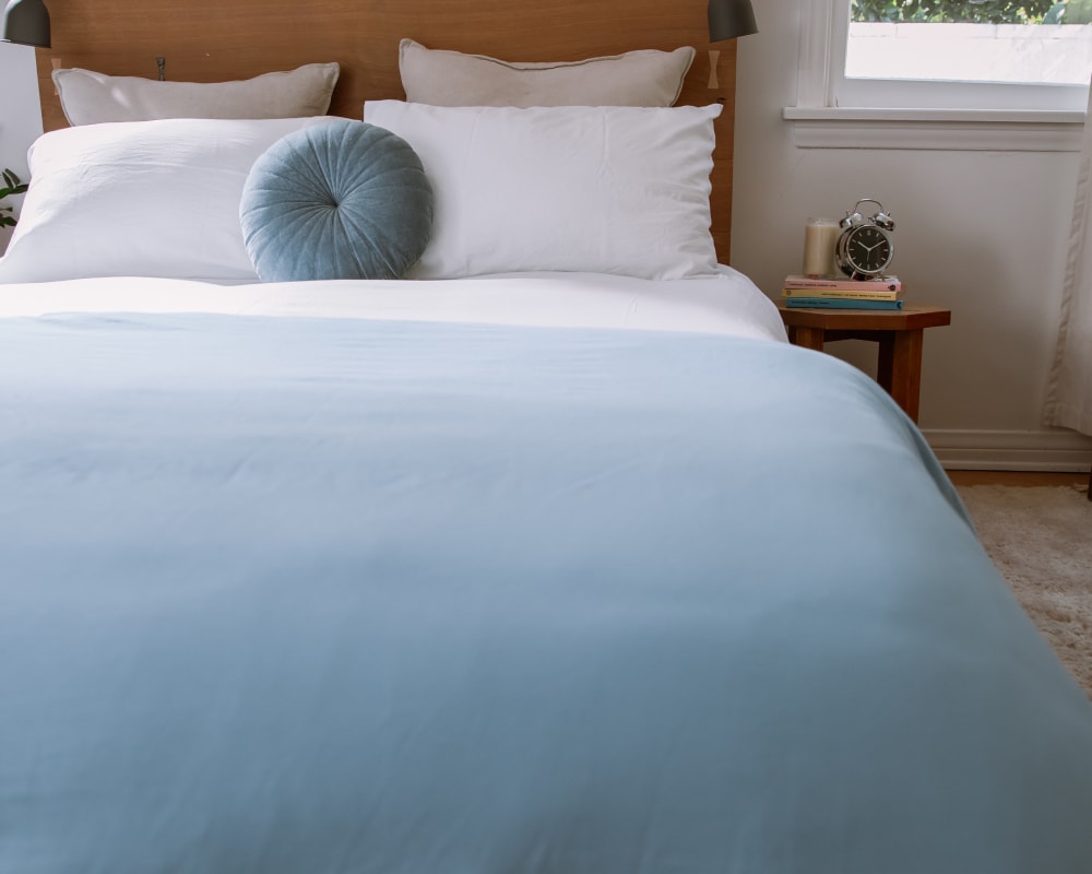 Dusty Blue Basics by Gravity Cotton Duvet Cover laying on a neatly made bed  - #color_dusty-blue