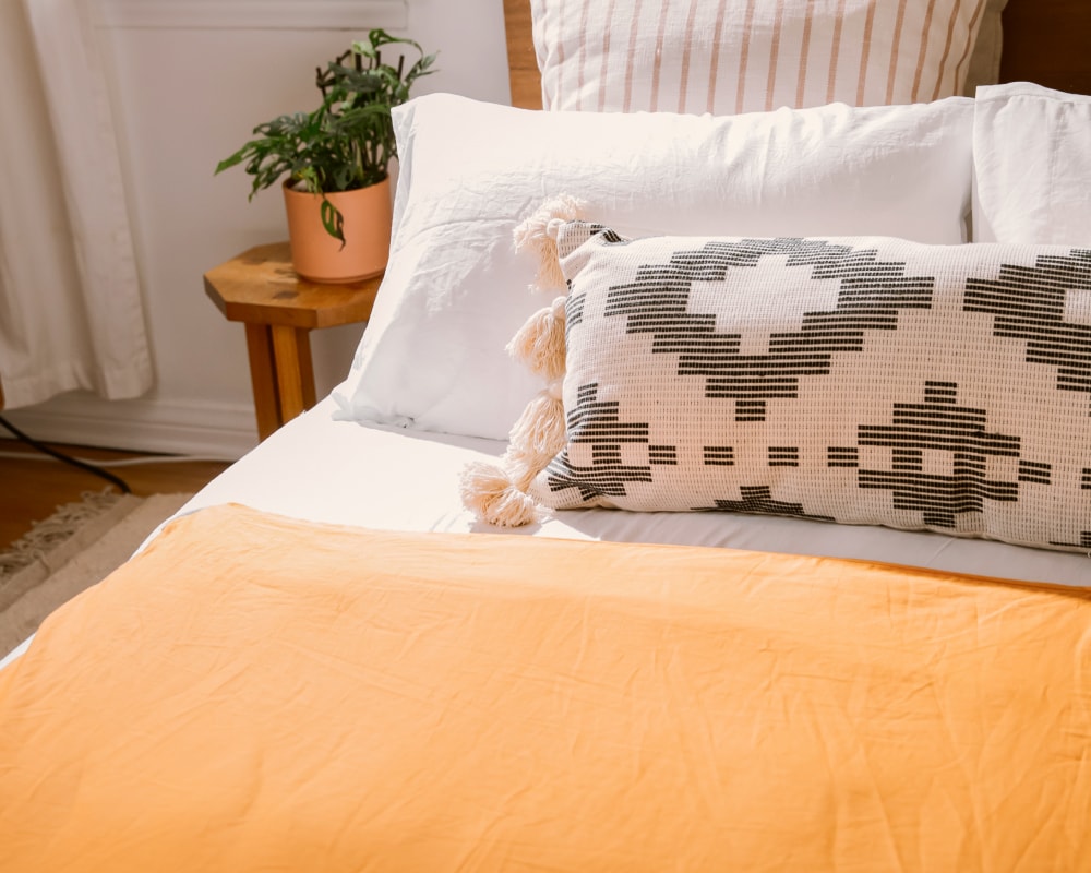 Ochre Basics by Gravity Cotton Duvet Cover laying on a neatly made bed  - #color_ochre