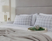 Made bed with grey flannel gravity sheets for comfortable sleep