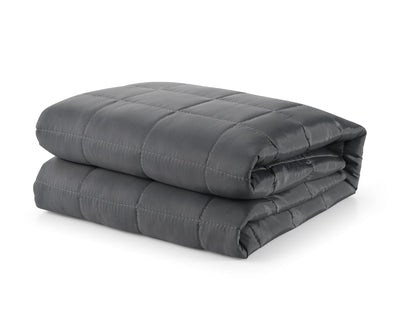 Grey travel blanket with breathable technical fabric folded against a white backdrop #color_grey