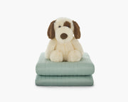 green gravity weighted blanket for kids folded with a teddy stacked on top
