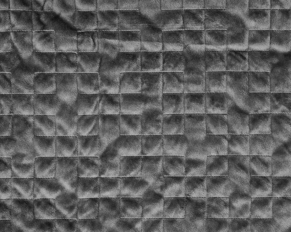 Closeup of stitching on plush grey fabric - #color_grey