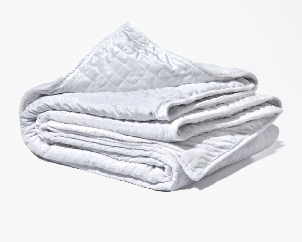 Original weighted blanket by Gravity in a plush white fabric folded against a white backdrop - #color_white