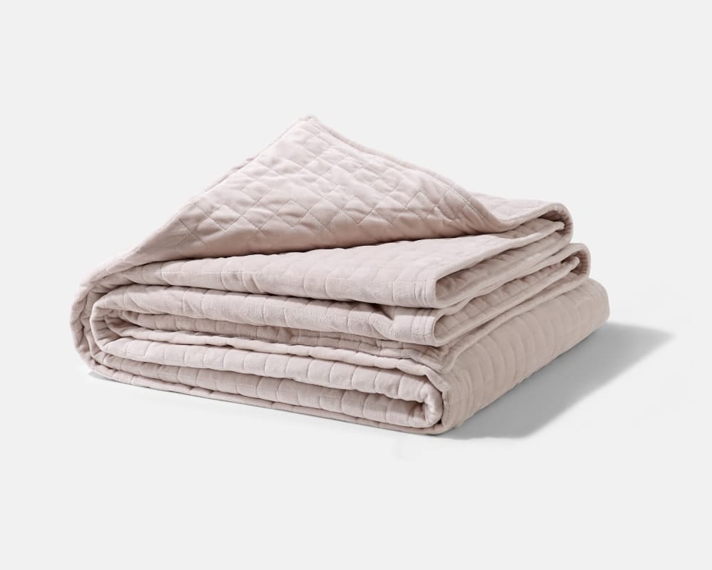 Original weighted blanket by Gravity in a plush oat fabric folded against a white backdrop - #color_oat