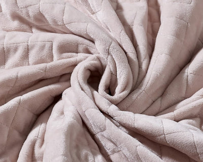 Original weighted blanket by Gravity in a plush gold fabric arranged in a spiral - #color_oat