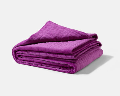 Original weighted blanket by Gravity in a plush plum fabric folded against a white backdrop - #color_plum