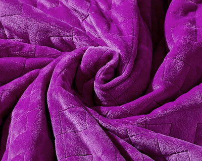 Original weighted blanket by Gravity in a plush gold fabric arranged in a spiral - #color_plum