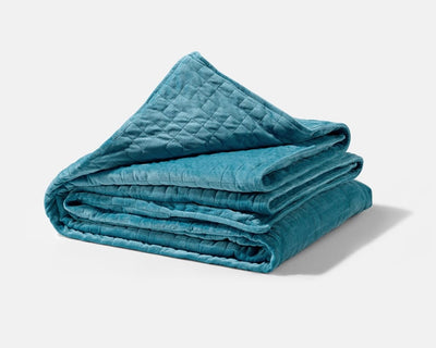 Original weighted blanket by Gravity in a plush teal fabric folded against a white backdrop - #color_teal