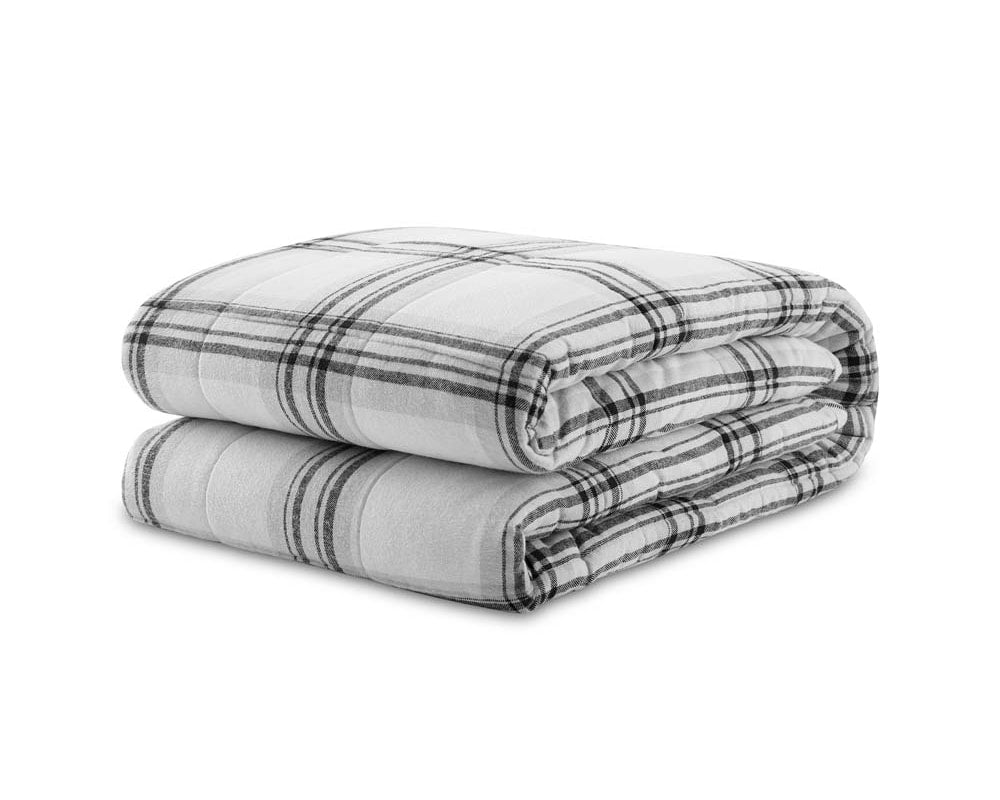 Weighted flannel sherpa blanket in dark grey plaid folded against a white backdrop #color_dark-grey-plaid