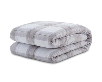 Light grey plaid flannel blanket folded against a white backdrop #color_light-grey-plaid