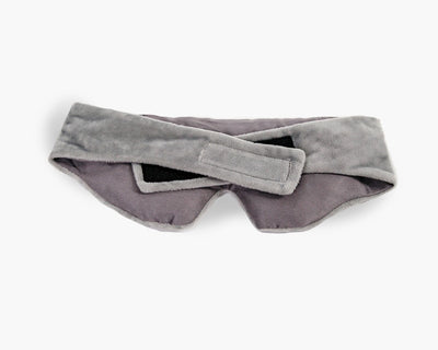 Velcro closure on a plush grey weighted eye mask